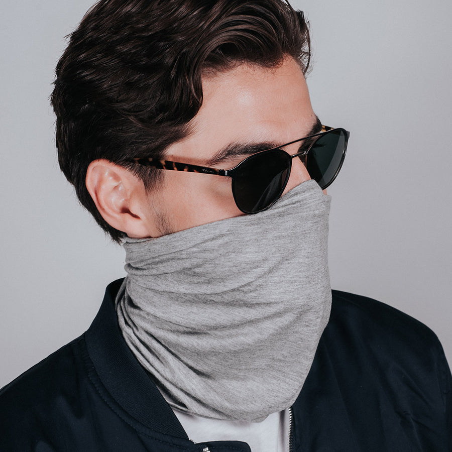 CoQau Casanova gray neck gaiter worn around the neck with hidden elastic loops to pull up as a mask when needed. Antimicrobial, Anti-aging and Aromatherapy smart fabric that repels germs and bacteria. Sustainable Modal fabric. Washable. Breathable. Comfortable mask